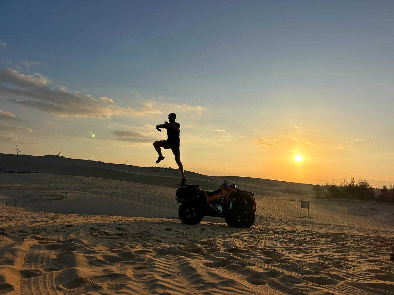 Travelers riding self-drive ATV on the Mui Ne sand dunes at sunrise